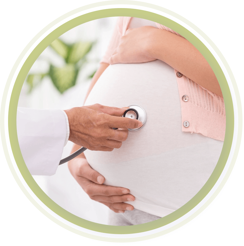A doctor holding up a stethoscope up to a pregnant woman